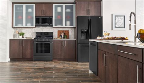 brown wood floor black cabinets and stainless steel appliances|black stainless steel kitchen cabinets.